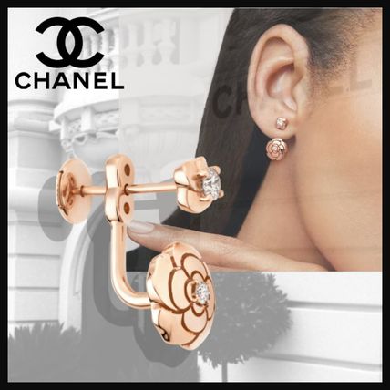 gold chanel earrings on ear